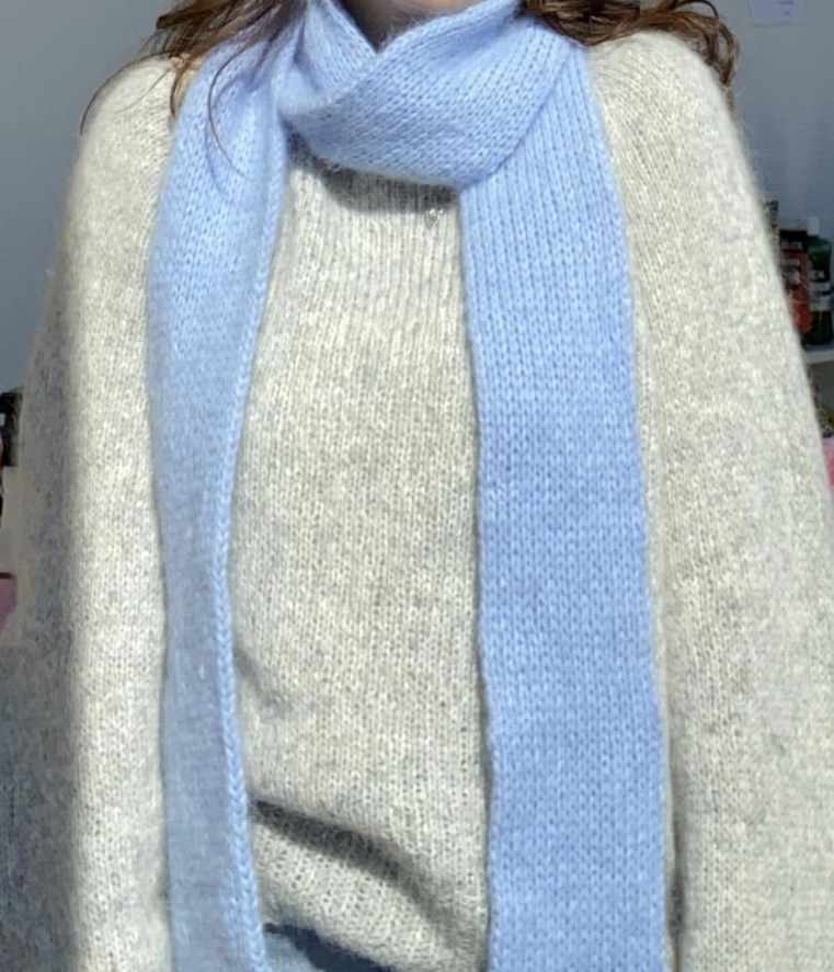 A knit scarf worn by a woman